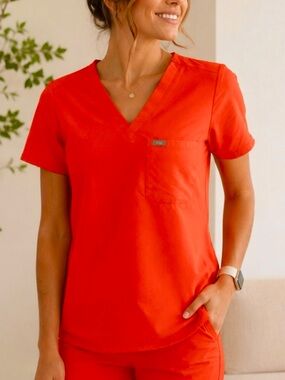 FIGS Technical Collection bright orange v neck scrub top